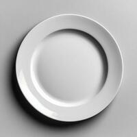 Minimalist white ceramic plate with smooth surface and blank center photo