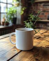clean white ceramic coffee mug on wooden table with greenery photo