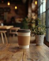 paper cup with lid on wooden table in cozy cafe setting photo