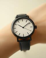 Elegant wristwatch with minimalist design and black leather strap photo
