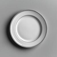 Elegant white ceramic plate with blank center and, decorative rim photo
