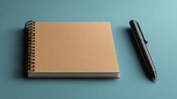 flat lay of blank notebook and black pen on teal background photo