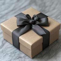 Elegant gift box with black ribbon on marble surface, perfect for special occasions photo