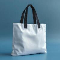 simple white tote bag with black straps on blue background photo