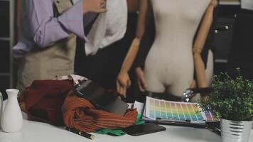 A mannequin is sitting on a table with a laptop and other items video