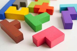 Logical thinking and problem solving problem solution creative business, wooden puzzle geometric block shape. photo