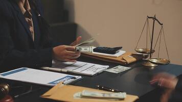A woman in a suit holding money and a scale video