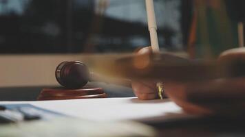 A judge's gavel on a desk with a pen and paper video
