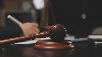 A judge's gavel on a desk with a pen and paper video
