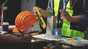 A construction worker is working on a model of a building video