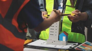 A construction worker is working on a model of a building video