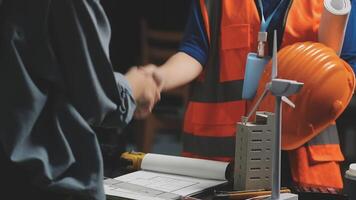 Two people shaking hands at a construction site video