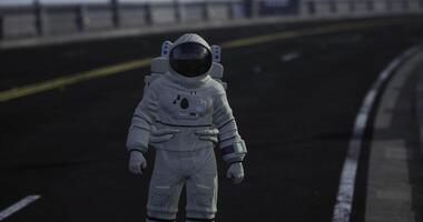 Astronaut stands on empty road during a clear daytime video