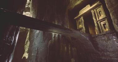 Exploring ancient rock formations and intricate carvings in a cavern video