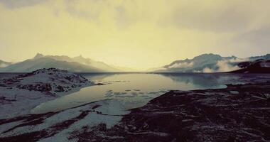Majestic twilight over a serene mountain lake with reflections of peaks video