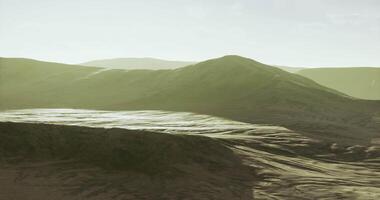 View of a serene desert landscape during golden hour with distant mountains video