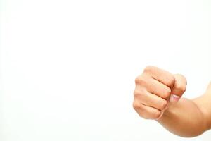 A clenched human fist on a stark white background displays aggression or determination photo