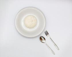 Overhead View of Steamed Rice on White Plate with Spoon and Fork photo