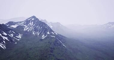 Snowy mountain landscape under a cloudy sky in a remote wilderness area video
