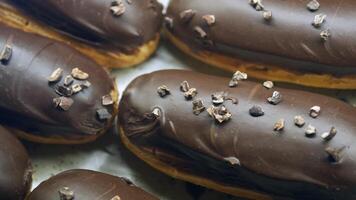 Delicious chocolate eclairs topped with crunchy sprinkles video