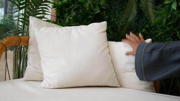 Cozy seating arrangement with soft pillows in a green setting video