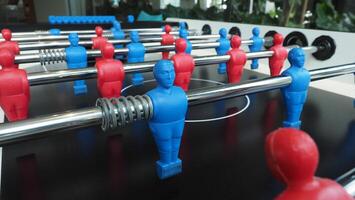 Football table or soccer table game with plastic player figurine. Mini Soccer game which famous in past and be collectable item for foosball lover. Play by two hand control each row player figurine. photo