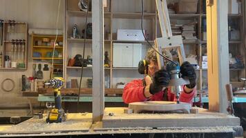 Carpentry workshop craftsman master working. Manual wood milling guy holds tool controlling process video