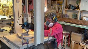 Carpentry workshop craftsman master working. Manual wood milling guy holds tool controlling process video