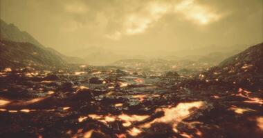 Fiery landscape with flowing lava under a hazy sky at sunset video