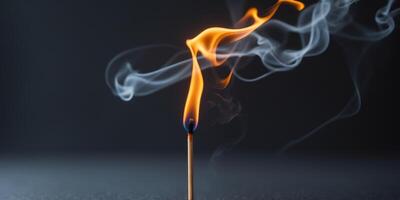 Bright flame dancing on a matchstick with wisps of smoke rising in a dark background photo