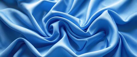 Vibrant blue fabric texture with elegant wrinkles and folds creating a dynamic visual flow suitable for design and textile backgrounds. photo