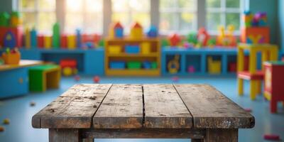 Empty wooden table on blurred background of kindergarten with big window and colorful furniture photo