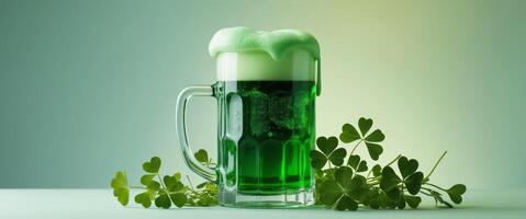 Green beer with foam in mug surrounded by shamrocks. photo