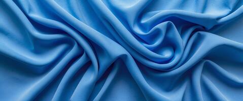 Vibrant blue fabric texture with elegant wrinkles and folds creating a dynamic visual flow suitable for design and textile backgrounds photo