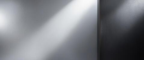 Shiny metal surface with a textured finish reflecting light and darkening on the right side. photo