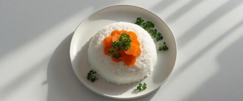 A plate of rice with carrots and parsley on top. photo
