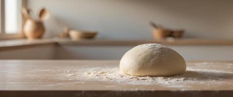 Dough ball resting on a floured surface ready for rolling in a cozy kitchen setting photo