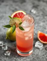 Refreshing citrus cocktail garnished with lime and grapefruit on a stone countertop photo