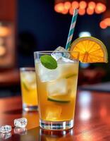 Refreshing cocktail served in a glass with citrus slices and mint on a wooden table at a trendy bar during evening hours photo