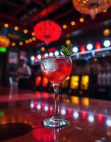 Vibrant cocktail served in an elegant glass with mint garnish at a lively bar with colorful lights photo