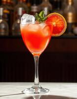 Refreshing cocktail garnished with citrus and mint served in an elegant glass at a modern bar during evening hours photo
