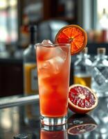 Refreshing cocktail with citrus garnish served in a bar setting during the evening photo