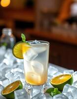 Refreshing drink served in a glass with lime and mint on a bed of ice in a cozy setting at dusk photo