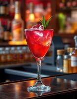 Refreshing red cocktail with mint garnish served at a stylish bar during evening hours photo