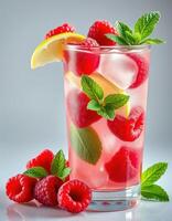 Refreshing raspberry lemonade served in a glass with mint leaves and ice during a sunny afternoon photo