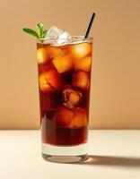 Refreshing iced tea with ice cubes and mint leaf served in a tall glass on a smooth surface photo
