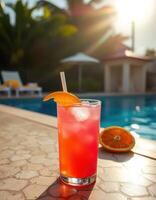 Refreshing tropical drink by the poolside in a sunny tropical setting during late afternoon photo