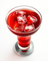 Refreshing red beverage served in an elegant glass with ice cubes on a bright background during a summer afternoon photo