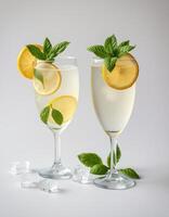 Refreshing lemon mint beverages presented in elegant glasses with ice on a minimal background photo