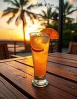 Refreshing beverage served at sunset in a tropical setting near palm trees photo
